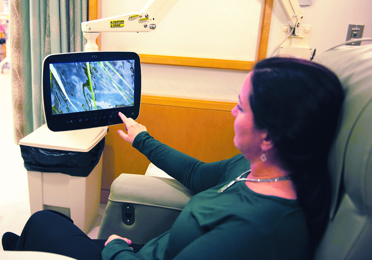 06 Linda Cummings Sensing Nature Patient watching Touching the Farm RIver video in Smilow Infusion Room (KEY IMAGE) 2014